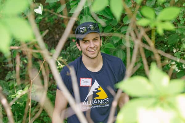 Mason sporting an Alliance logo t-shirt while participating in a Project Clean Stream event.