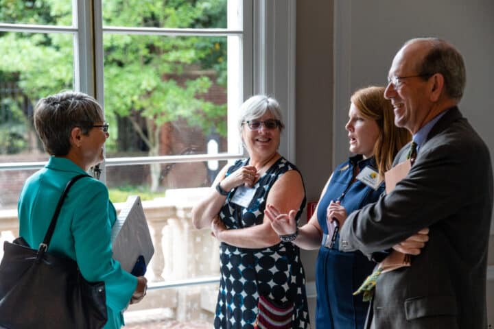 A group of people smiling and talking