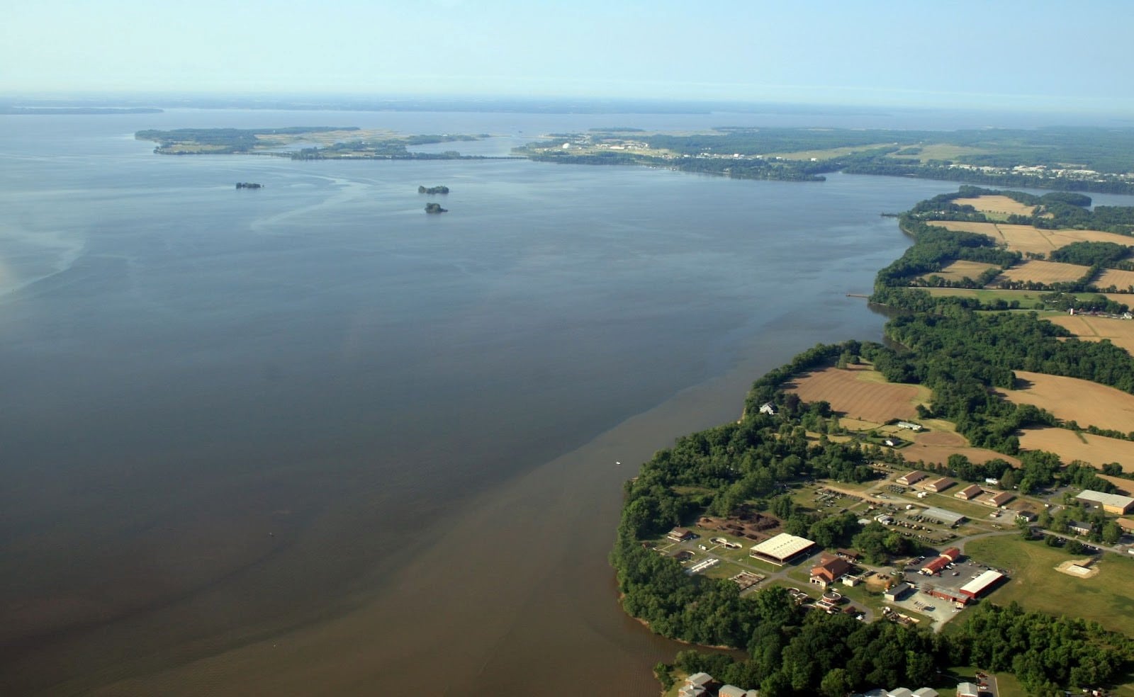 An aerial view of a coastline next to a large body of water