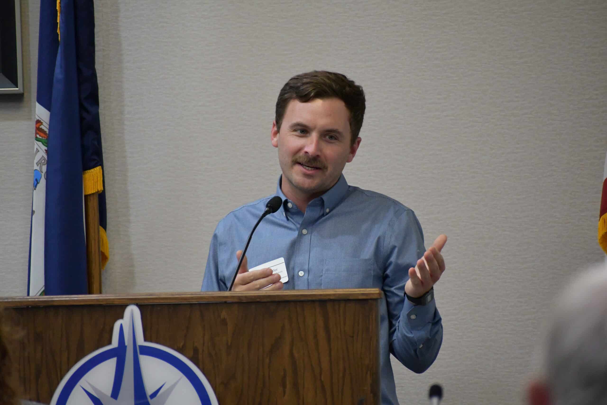 A person speaking behind a podium