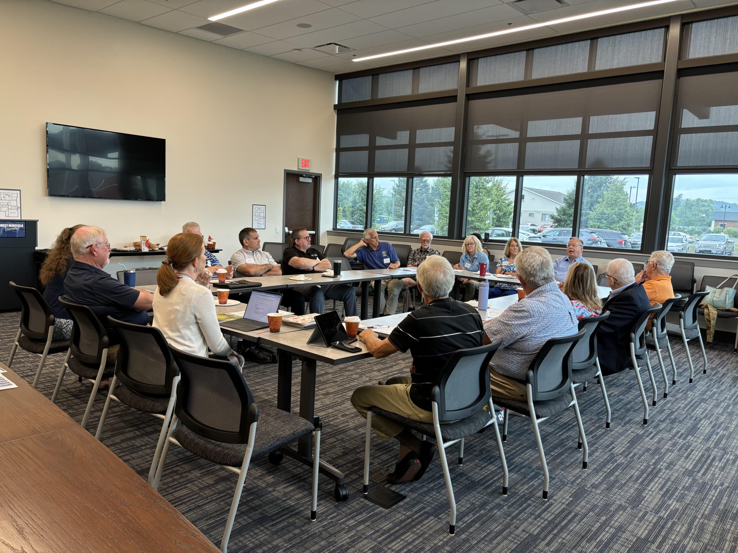 A group of people gathered around a table talking