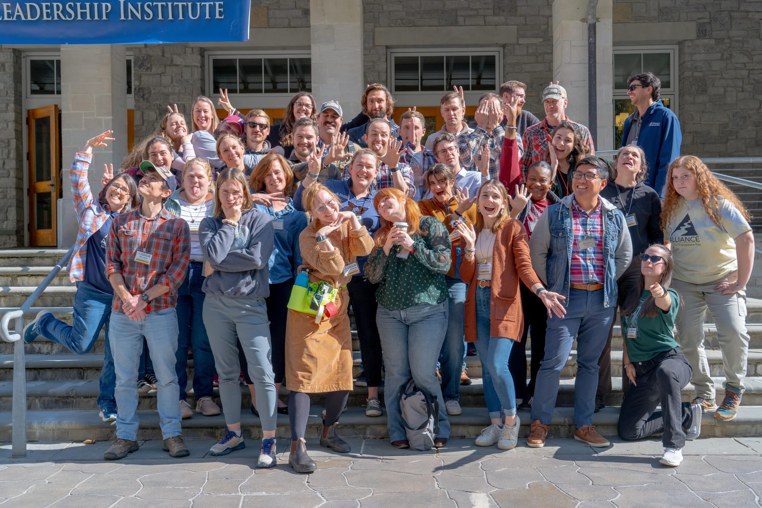 A large group of people posing for a photo on a set of stairs