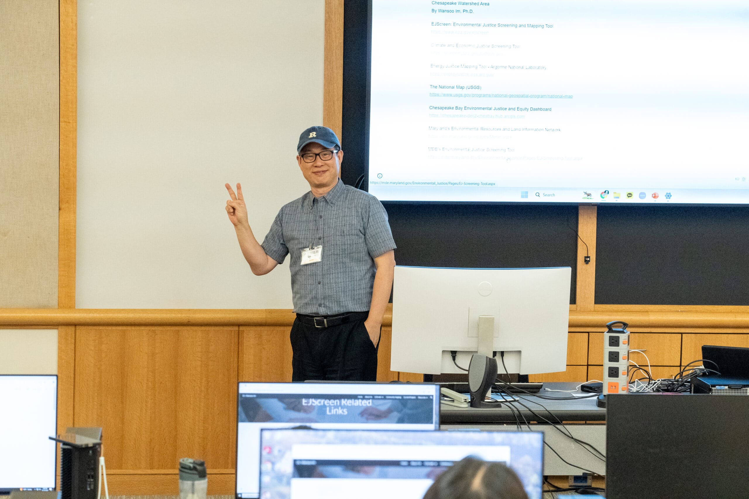 a person giving the peace sign while giving a presentation