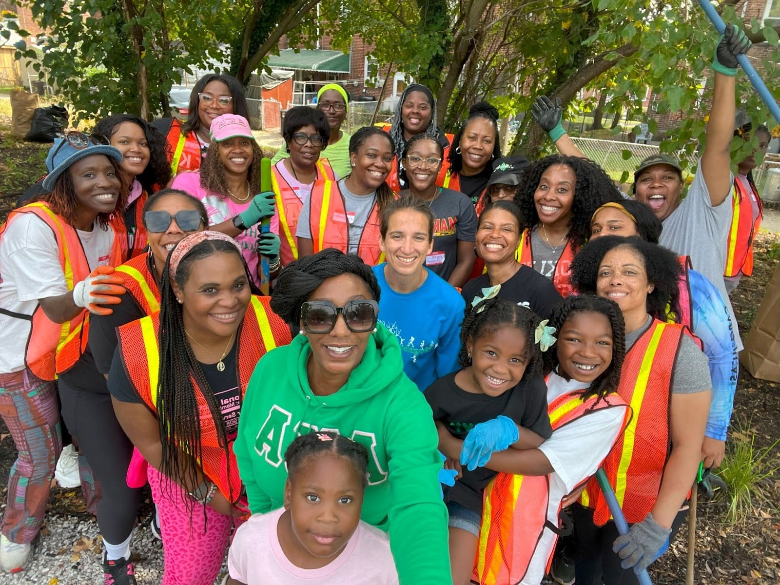 A group in orange high visibility vest posing for a picture